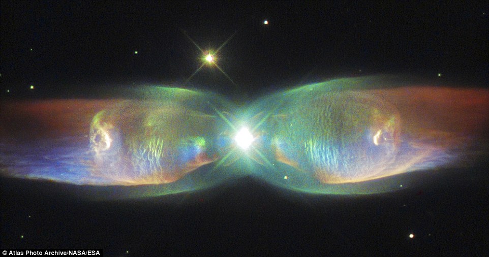 The majestic beauty of the dying Twin Jet Nebula has been revealed in incredible detail in a stunning new image by Hubble. Stretched out like iridescent butterfly wings, the image reveals the incredible complexity of the bipolar nebulas two shimmering lobes